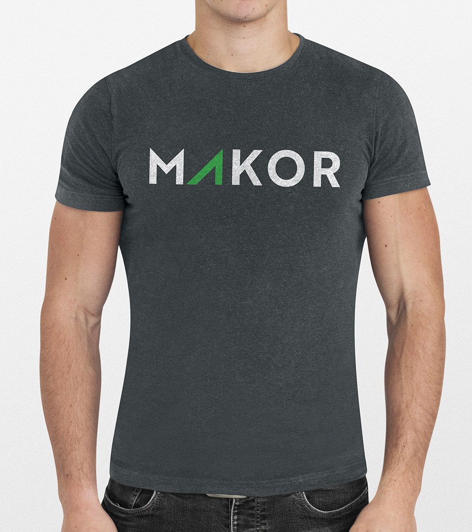 makor logo on gray t shirt being worn by young man copy