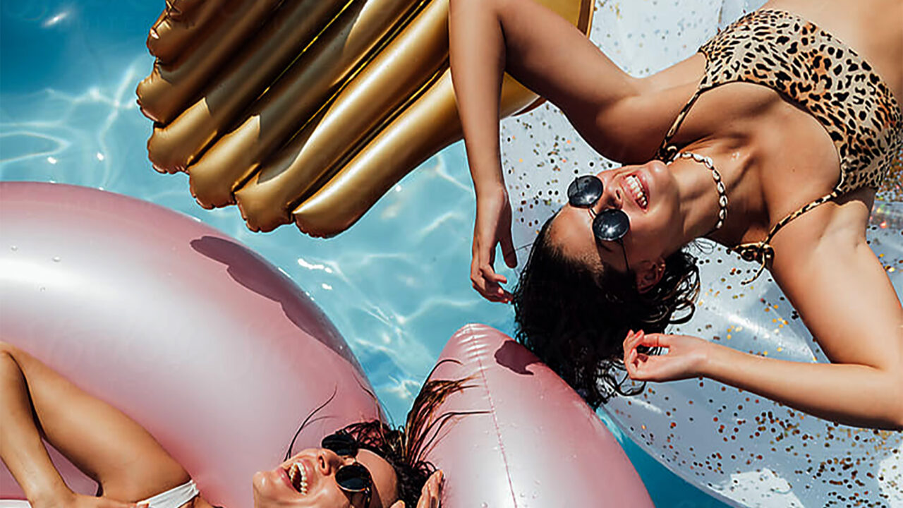 one canal 2 girls on floats in pool