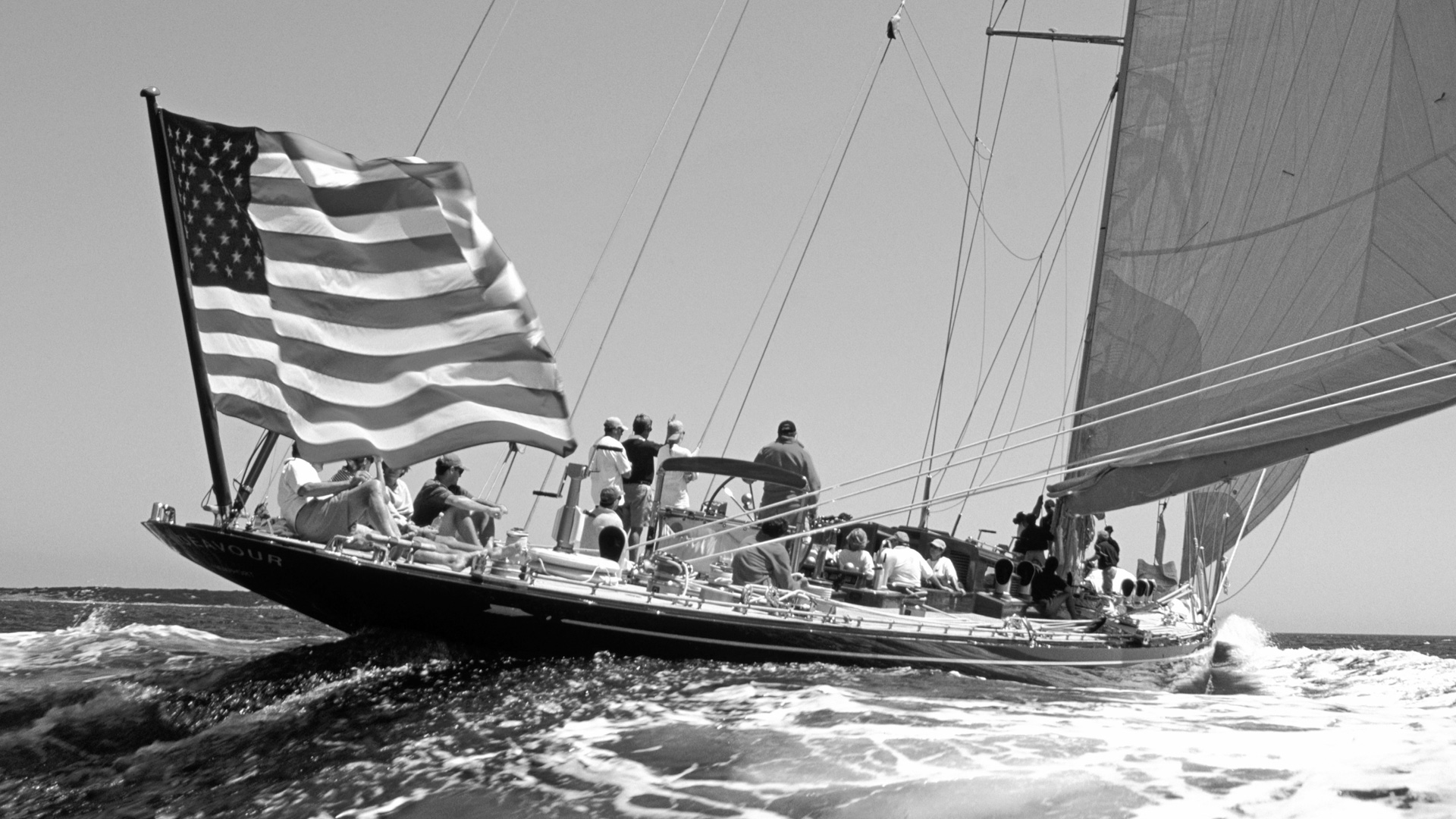 fan pier sail boat racing with american flag in black and white