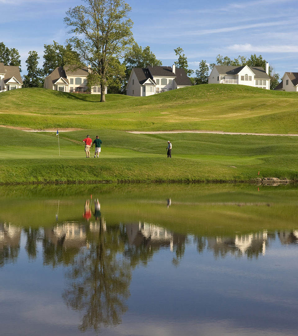 Merrimack Golf Club with golfers and houses