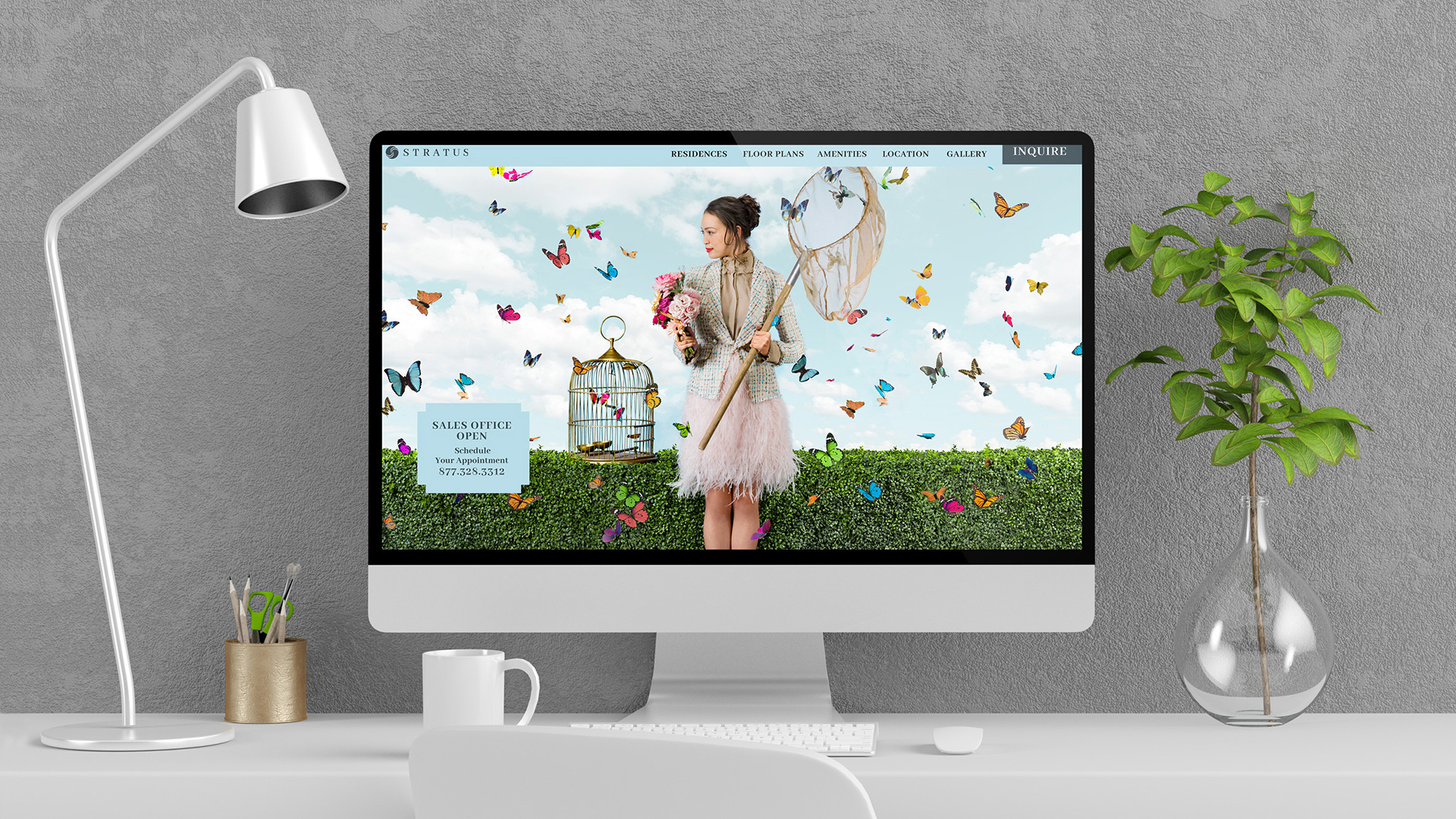 stratus residences woman with butterflies on imac sitting on desk