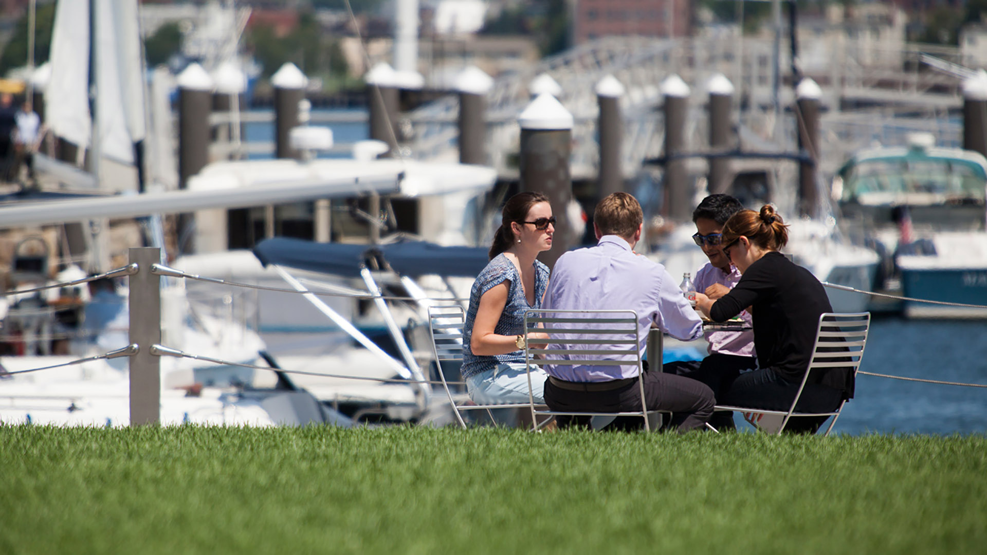 twenty two liberty friends at outdoor cafe table with boats in background