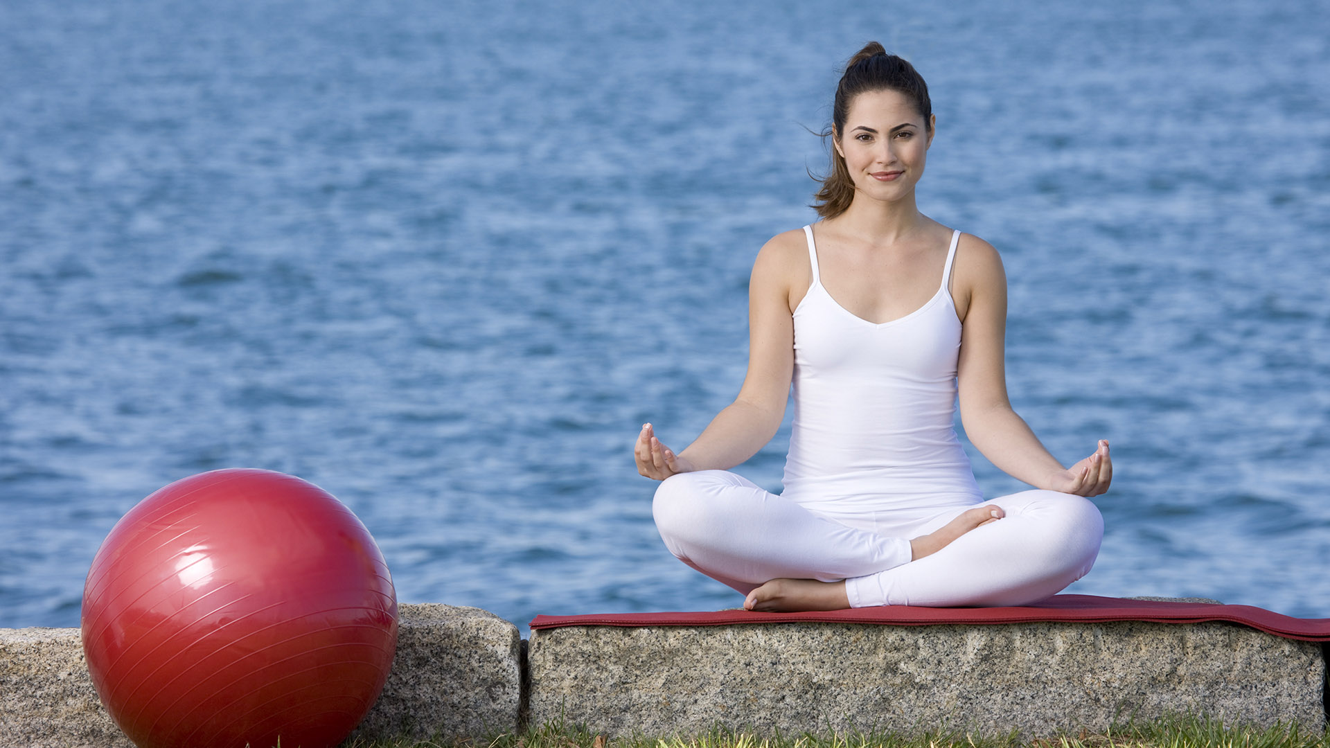 twenty two liberty girl in yoga pose with red ball