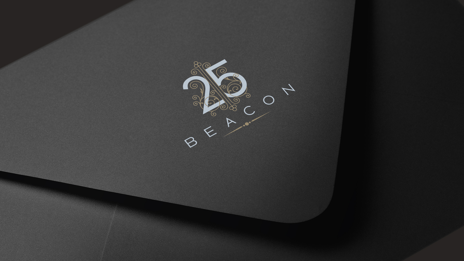 25 beacon identity logo on black envelope