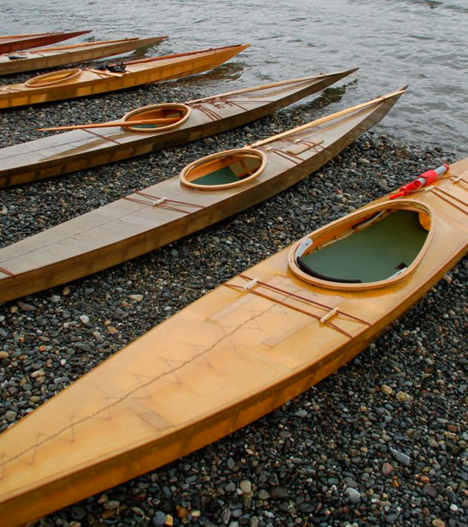 Boston East orange kayaks on the shore