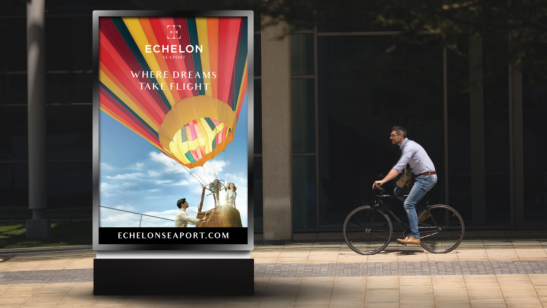 echelon seaport street sign with hot air balloon and person on bicycle in background