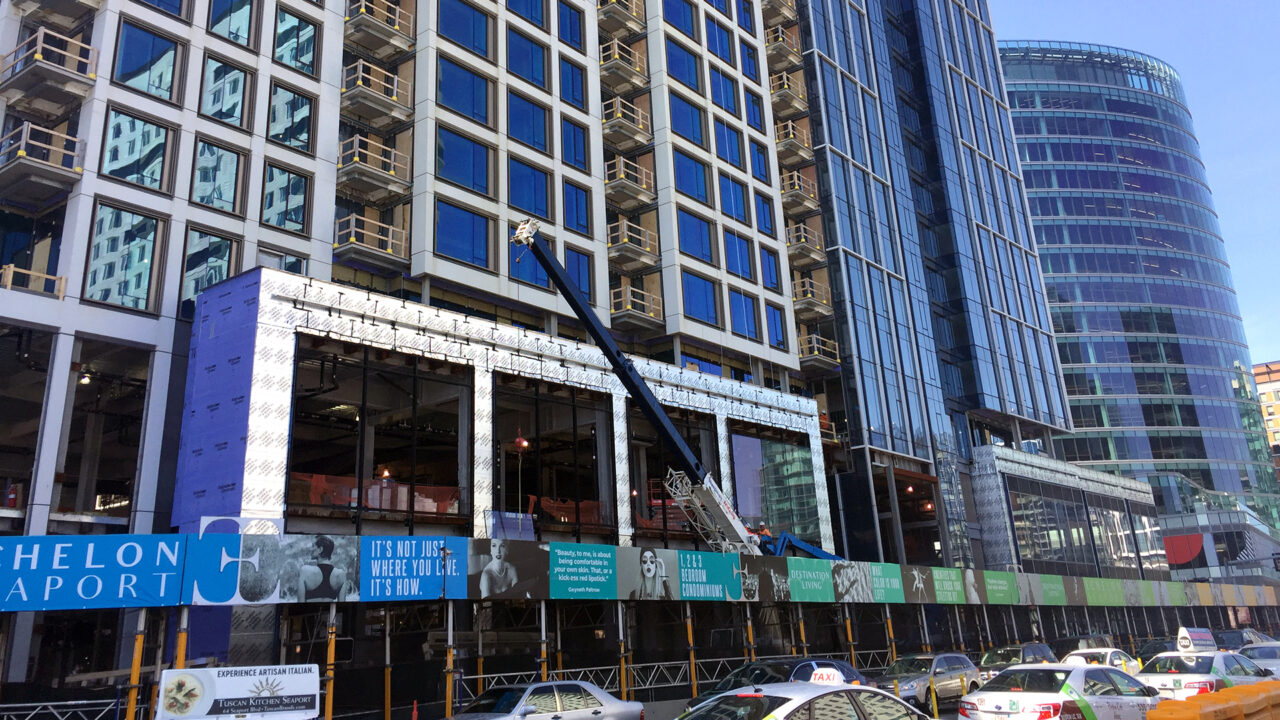 echelonseaport construction fence on building with blue and greens