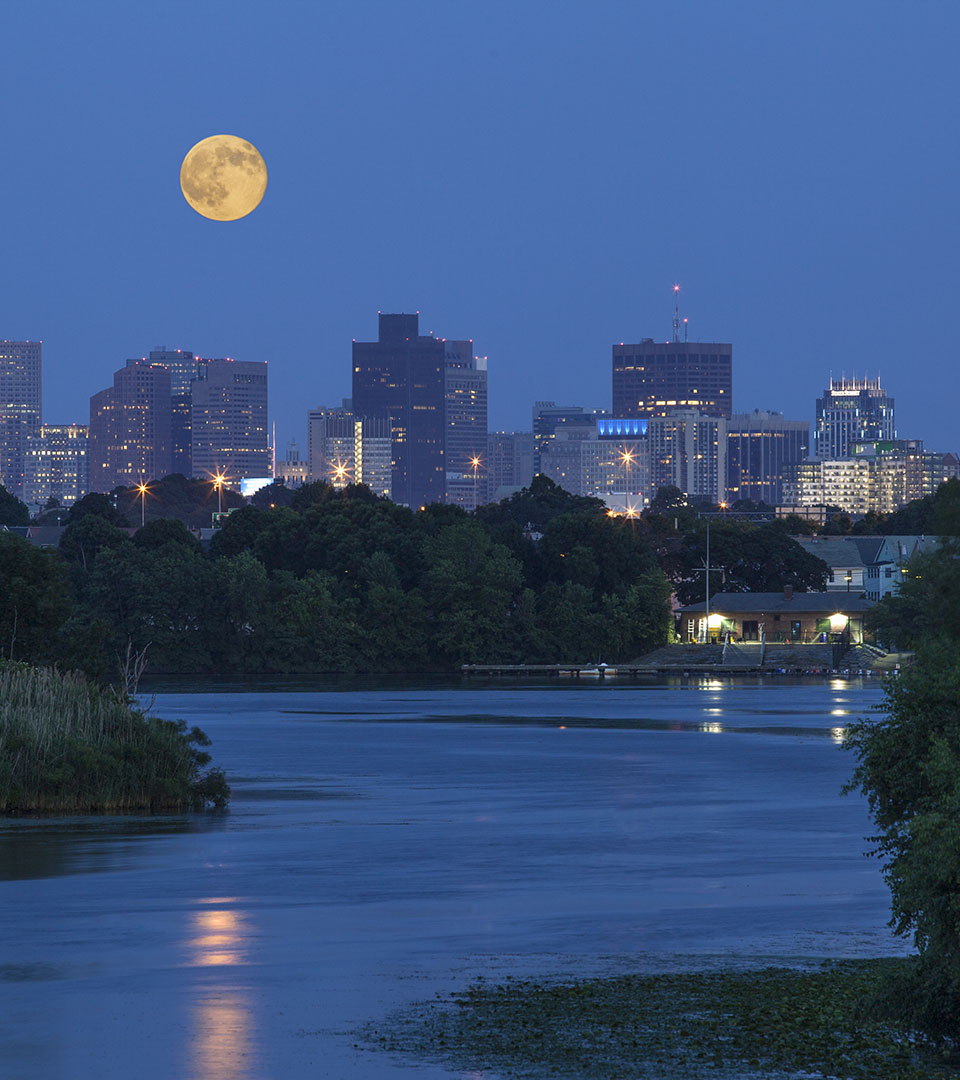 re150 river at night with moon and boston skyline