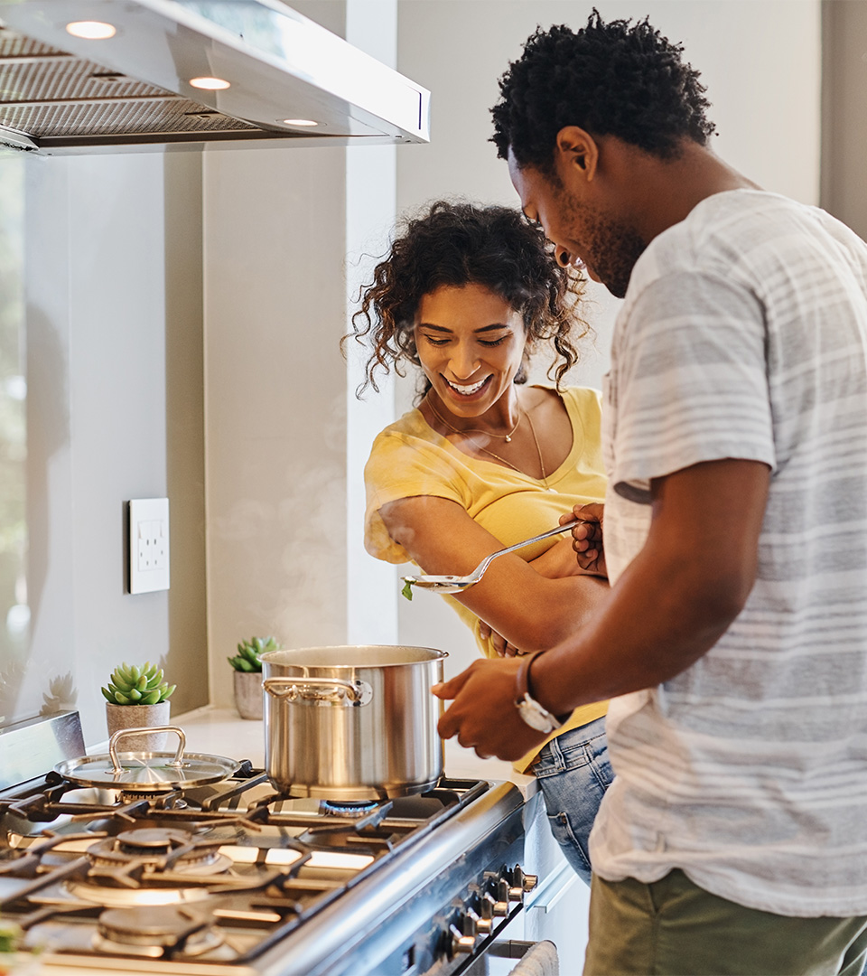 stratus black couple at stove cooking