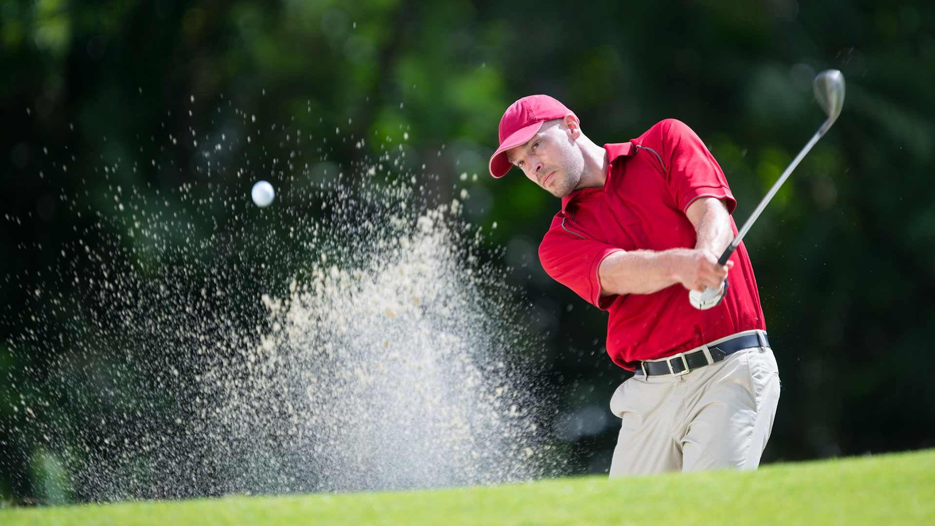 the cape club golfer in red shirt and hat hitting golf ball
