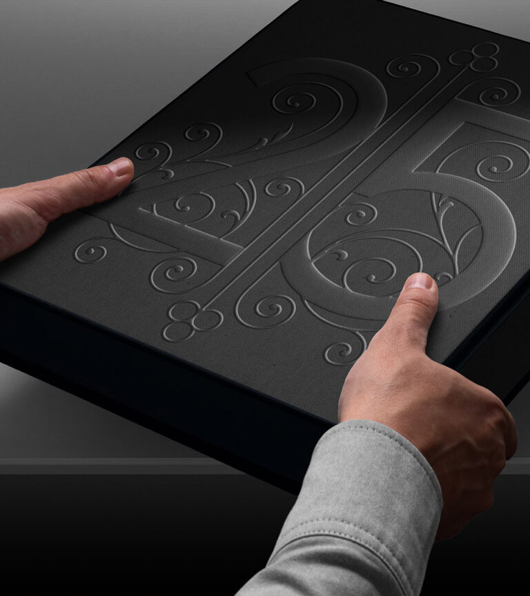 25 beacon embossed box held by two hands vertical