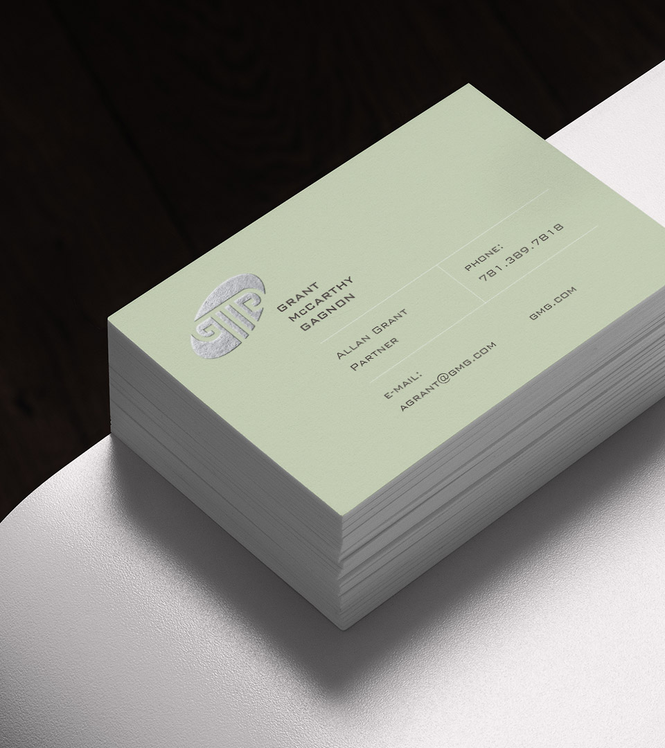 Grant McCarthy Gagnon busines card on white table vertical