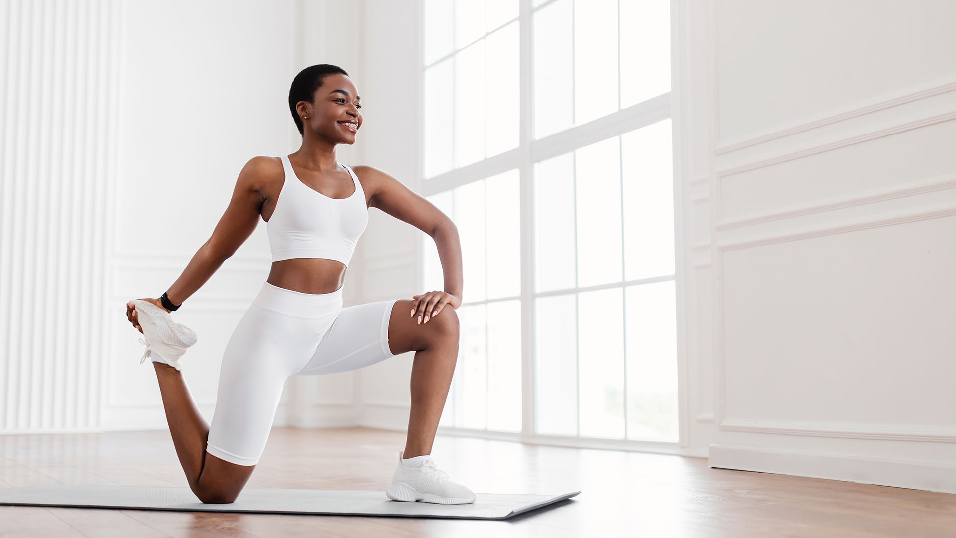 align pt and health african american woman kneeling on matt with white work out clothing