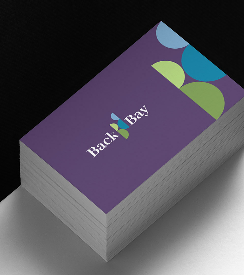 back bay association business card on white table vertical