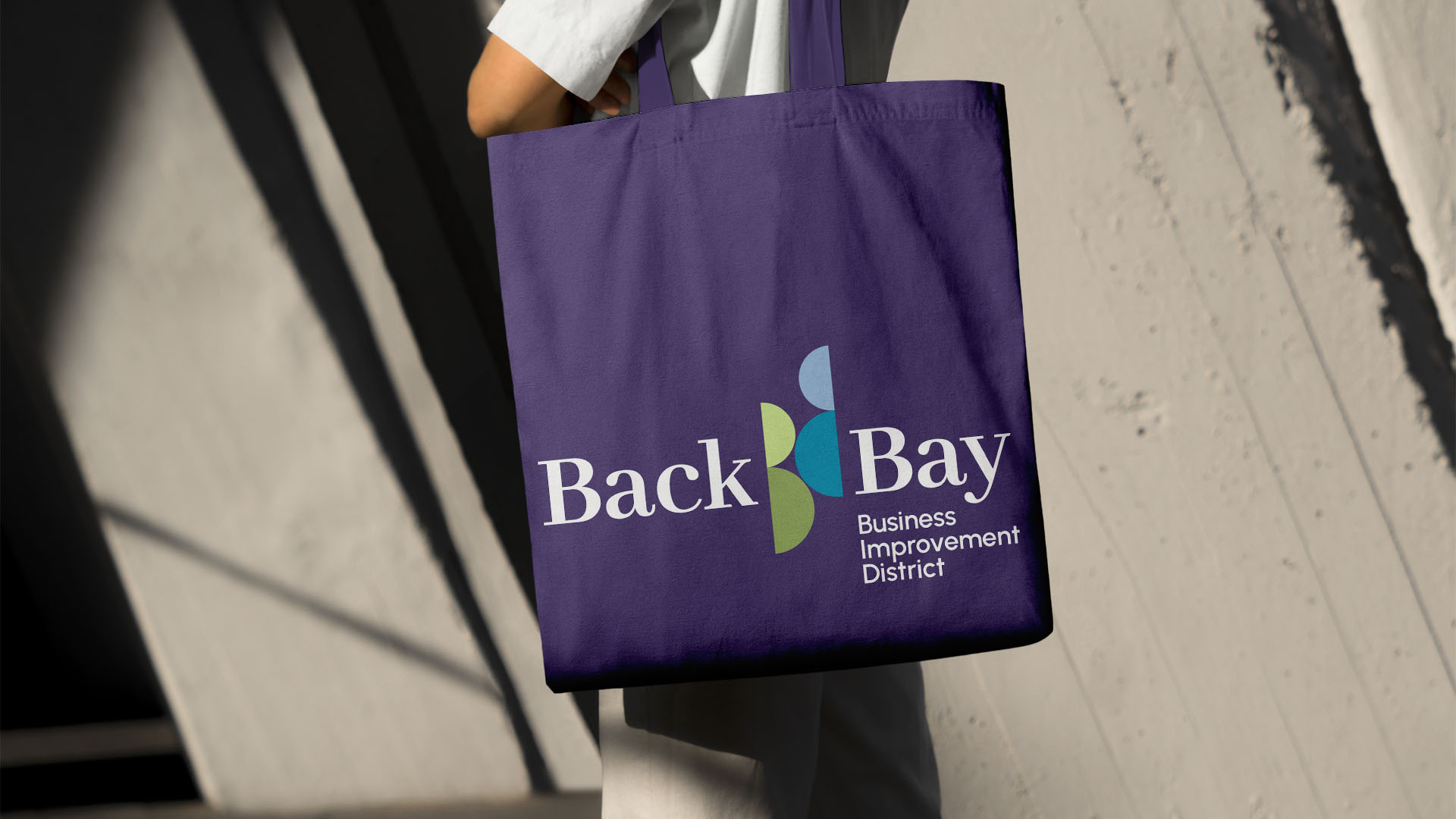 back bay business district logo on purple tote