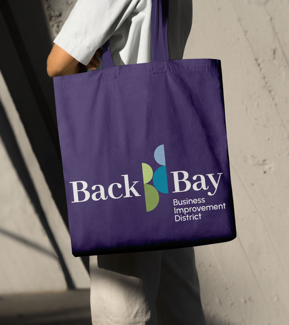 back bay business district logo on purple tote vertical