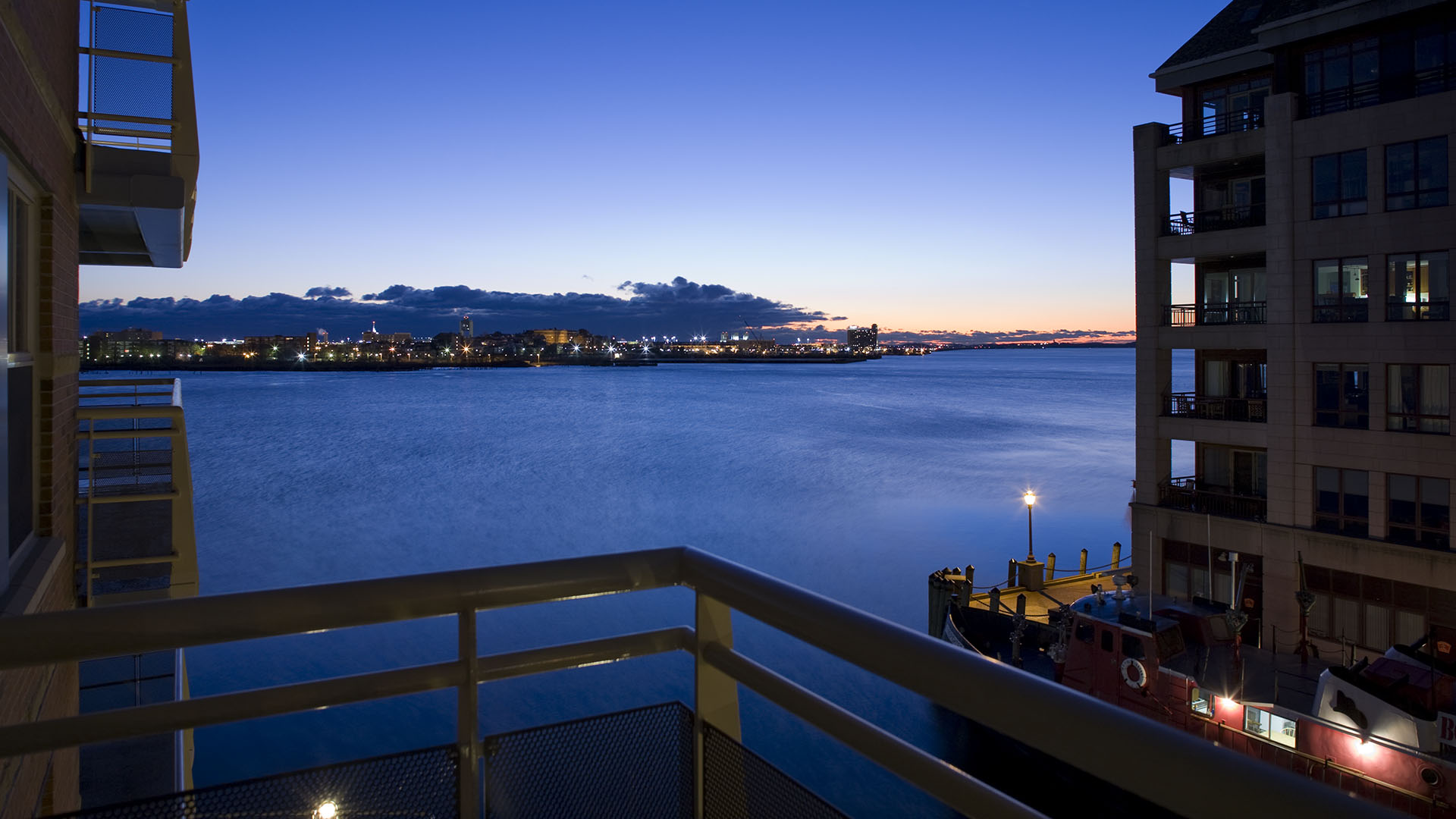 battery wharf view of sunset from buildings on harbor