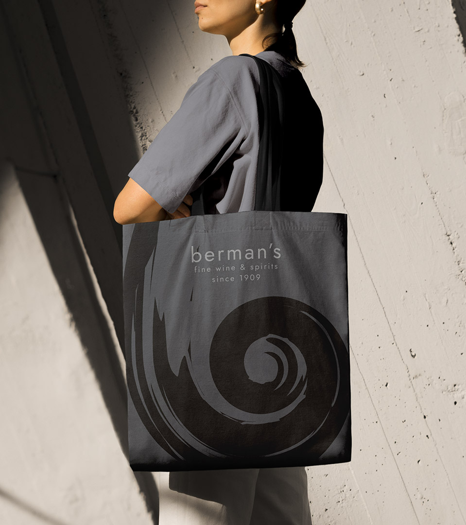 Branding and logo design in Boston for Bermans over the shoulder fabric gray bag with black logo