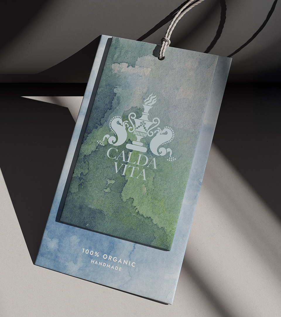 Boston-based graphic design and branding studio delivering memorable logos, identity systems, created the visual identity for Calda Vita including this hangtag with green and blue watercolor background for the blue logo.