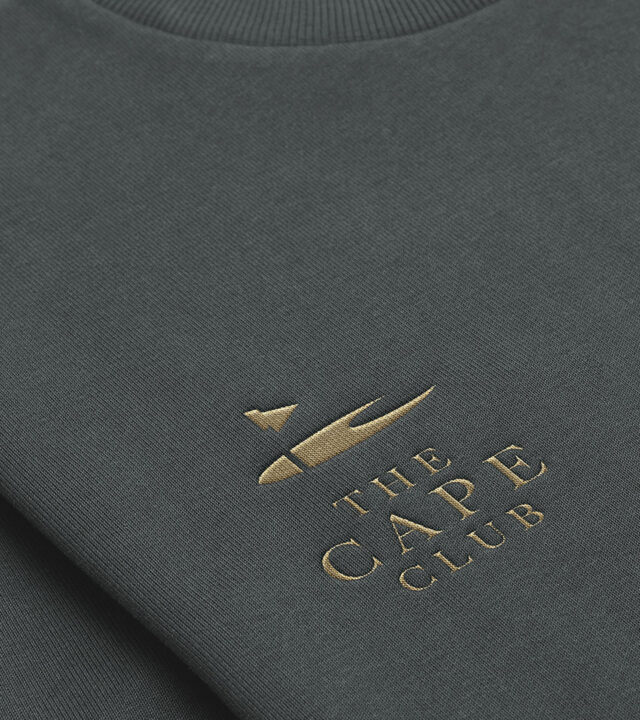 Print collateral for The Cape Club showcasing the unified residential and golf community branding.