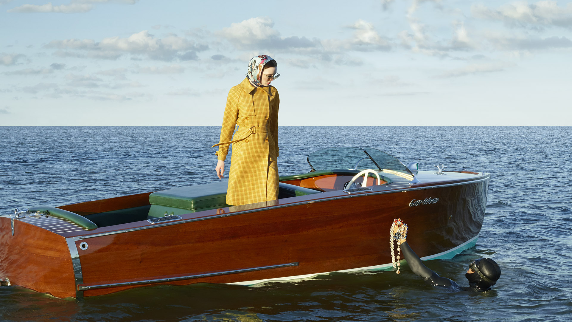 echelonseaport woman in a boat with yellow coat and diver