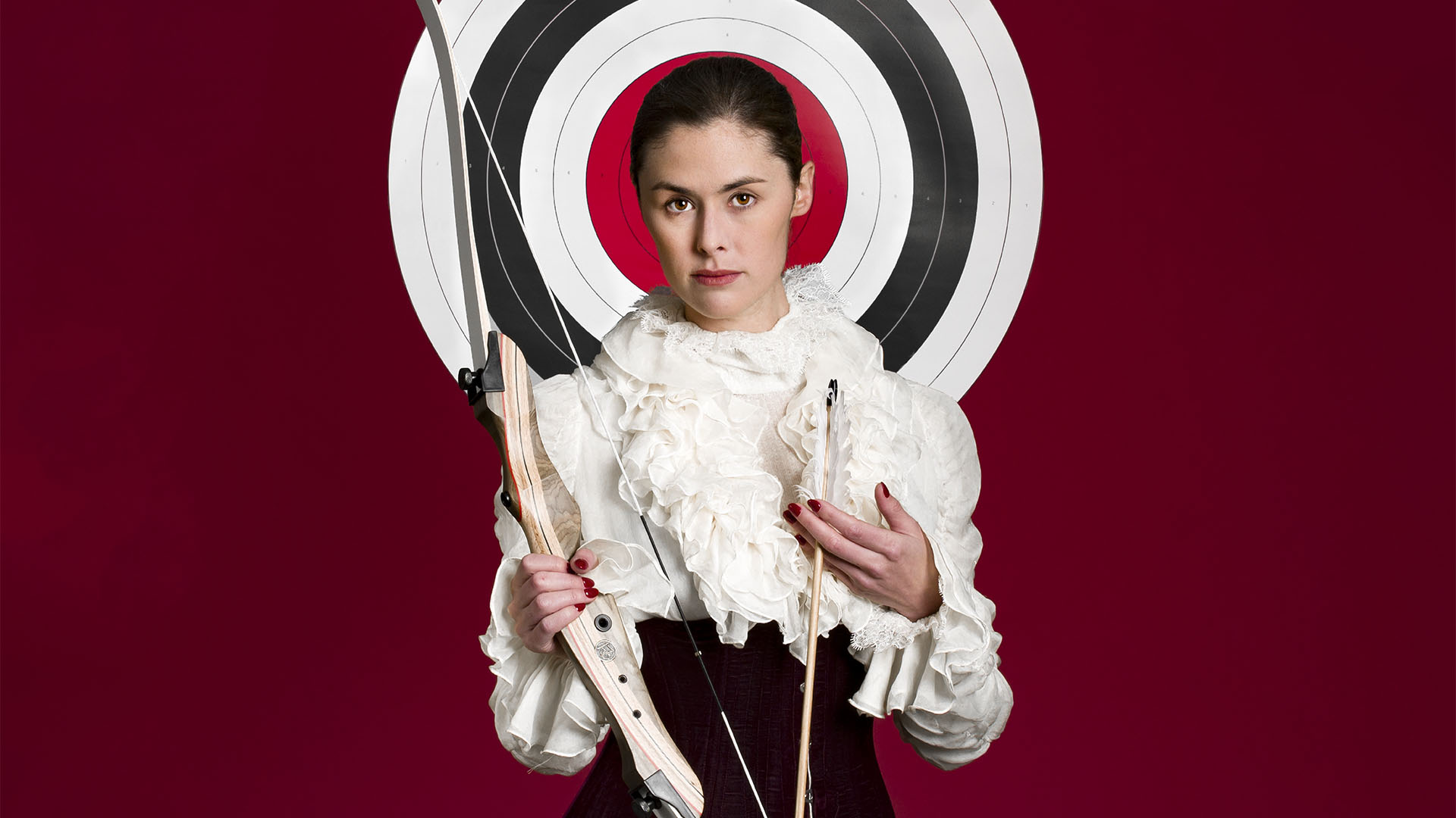 emma guardia archery with red background and target