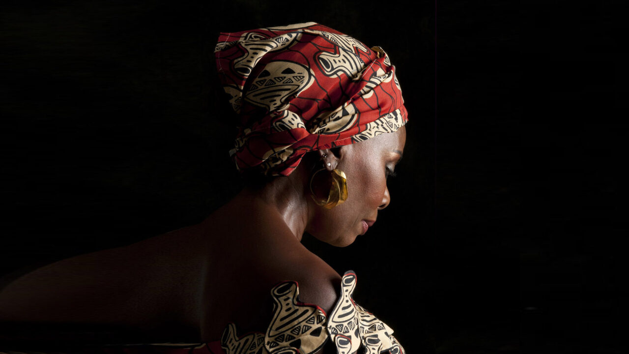 gaila fund african woman with red and black head scarf-horizontal
