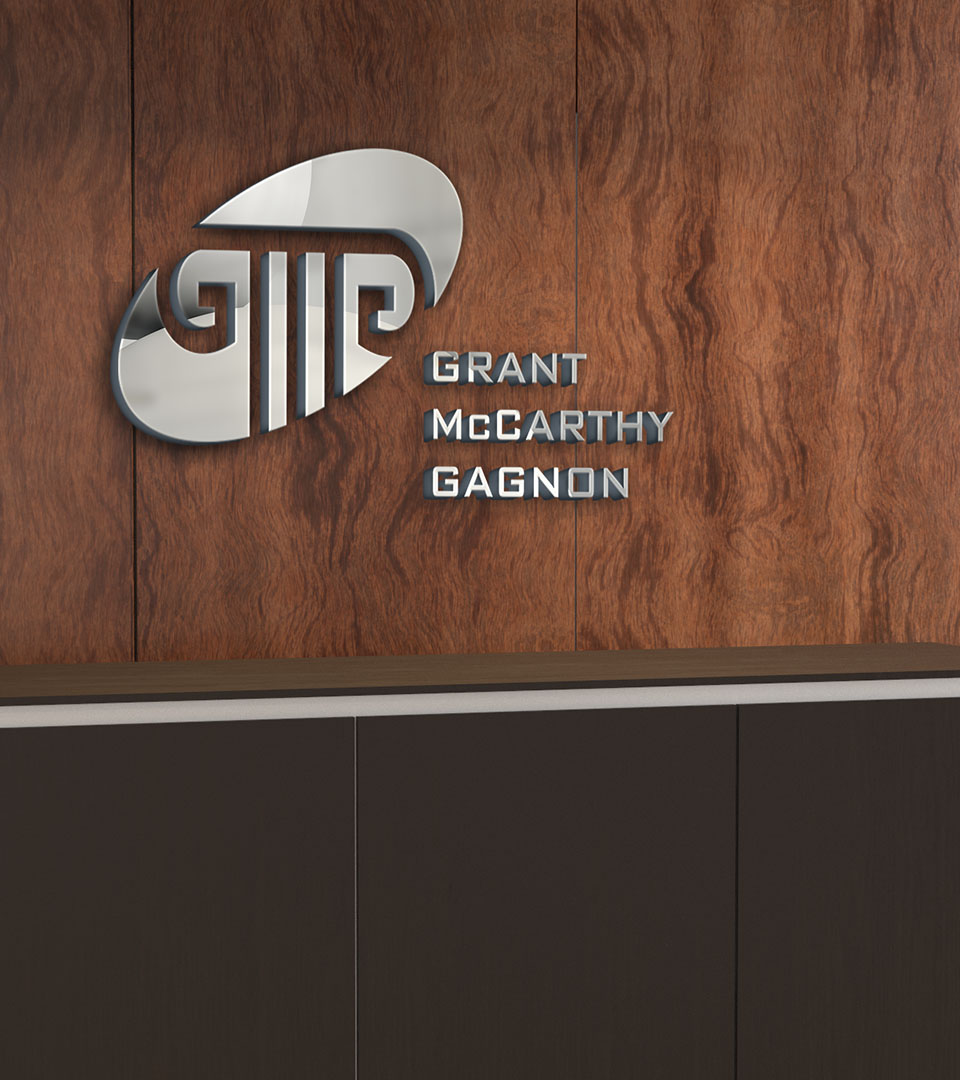 grant mccarthy gagnon logo in silver behind reception desk