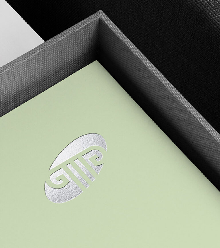 grant mccarthy gagnon silver logo on green in box vertical