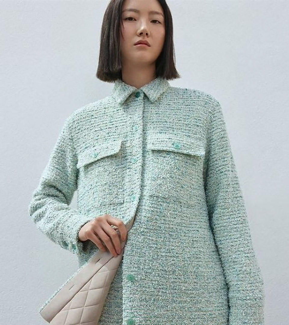 heritage on the garden oriental girl with aqua jacket and beige purse