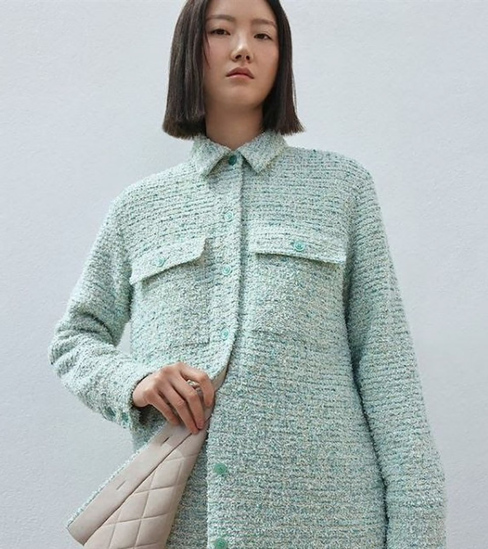 heritage on the garden oriental girl with aqua jacket and beige purse