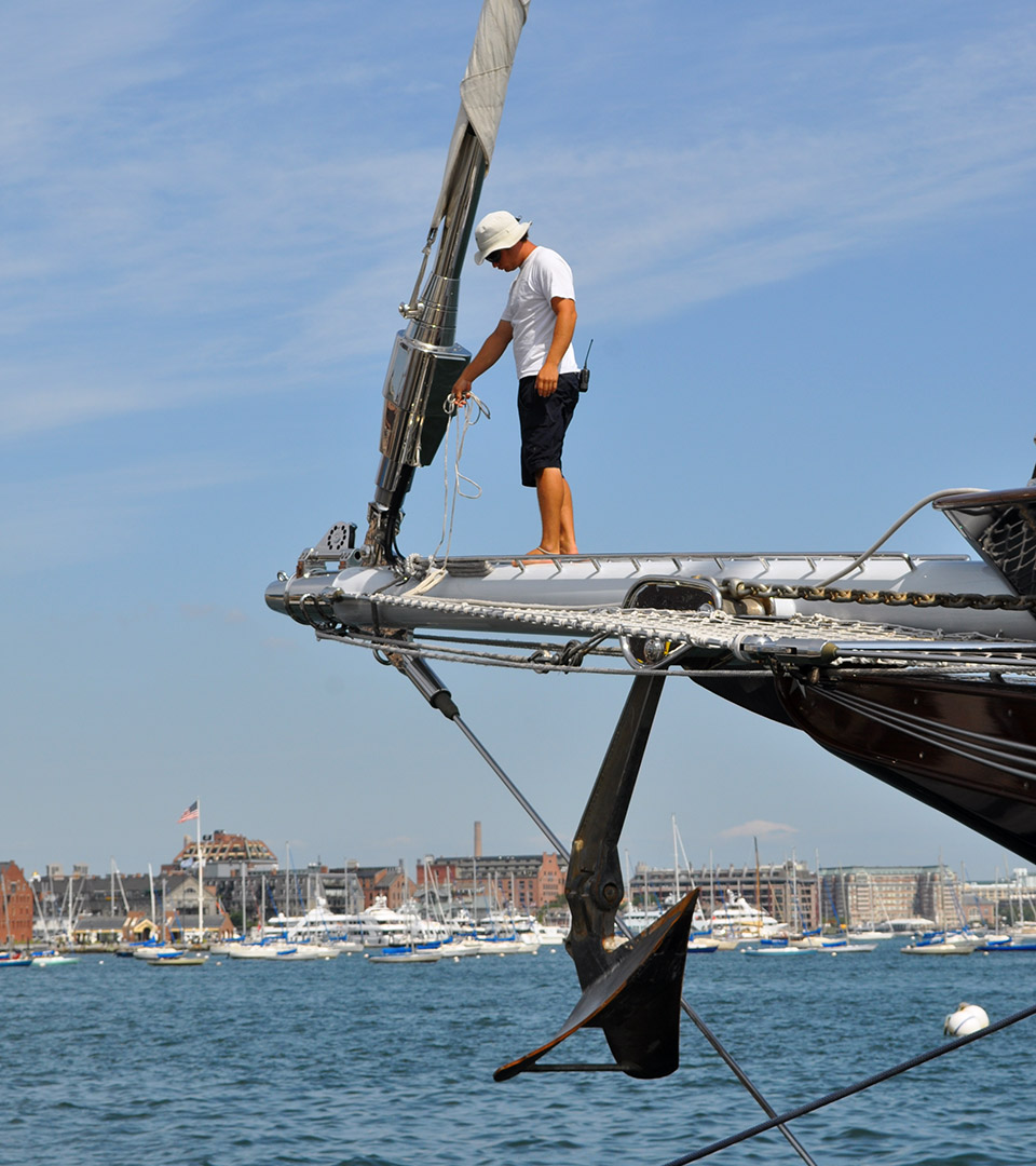 liberty wharf man on large sail boat dropping anchor