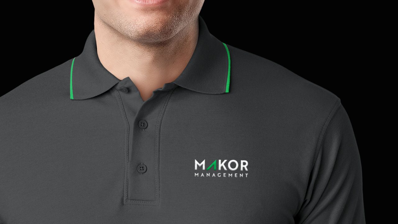 makor management dark gray polo shirt with black background