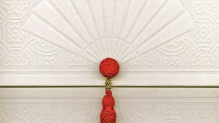 mandarin oriental box close up with red tassle cream color