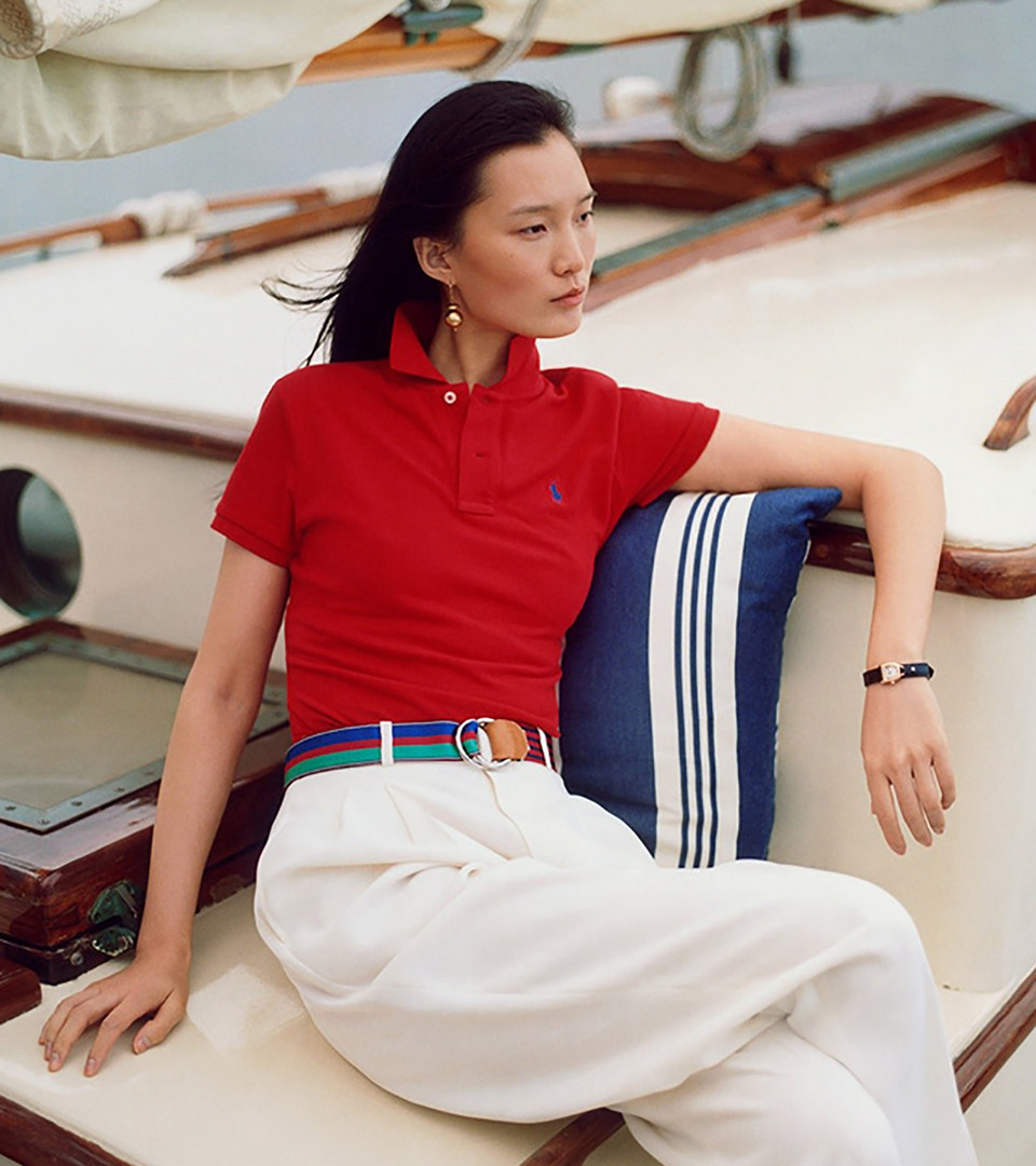 mirabelle bay asian woman on sailboat wearing red polo shirt and white pants