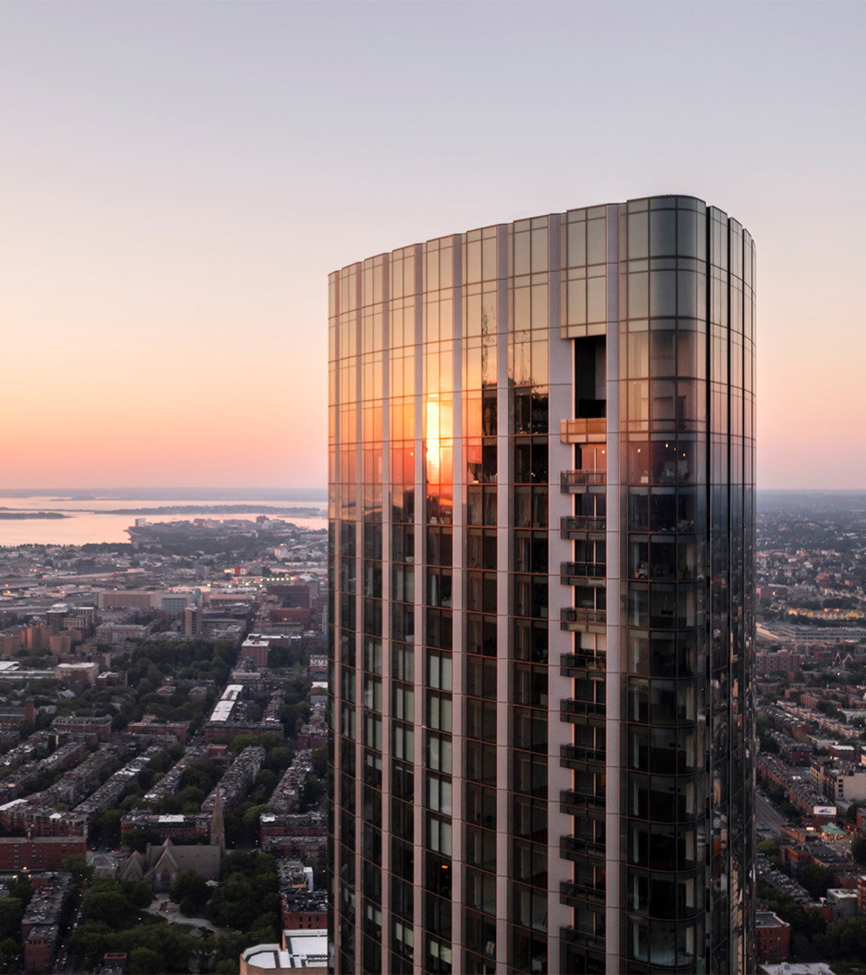 one dalton top of building looking out at sunset and river