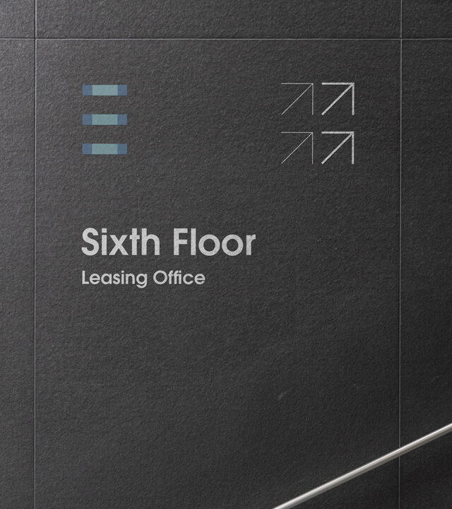 Leasing wall signage for One Exeter Plaza featuring the geometric architectural logo and modern visual identity for the Back Bay office tower.