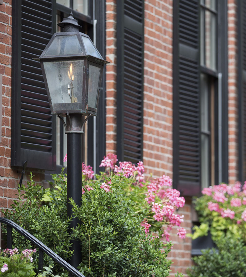 signet gas lamp with pink flowers on stairs