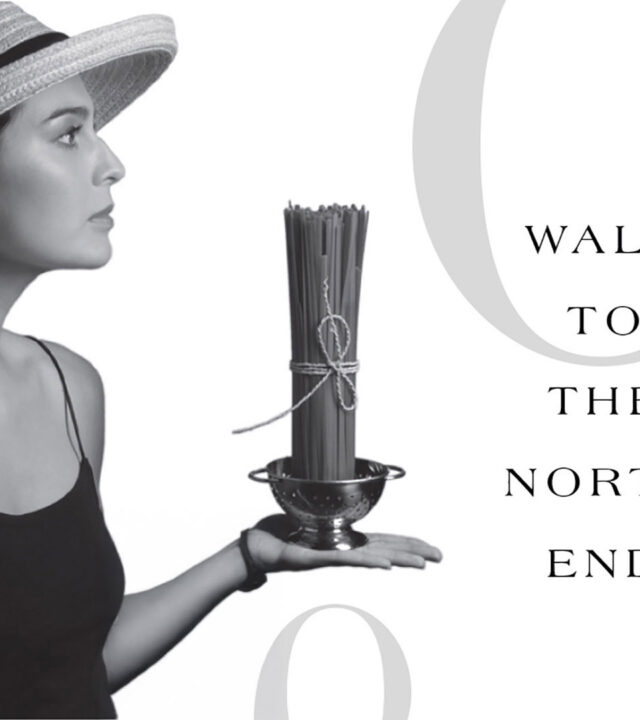 strada 234 woman holding pasta tied up and sitting in strainer vertical