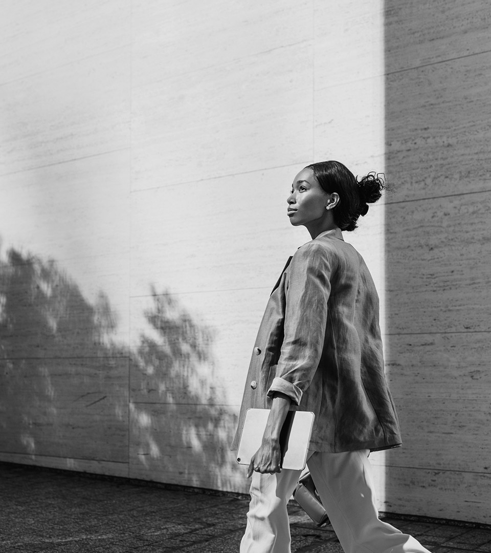 sudbury apartments black woman walking with laptop