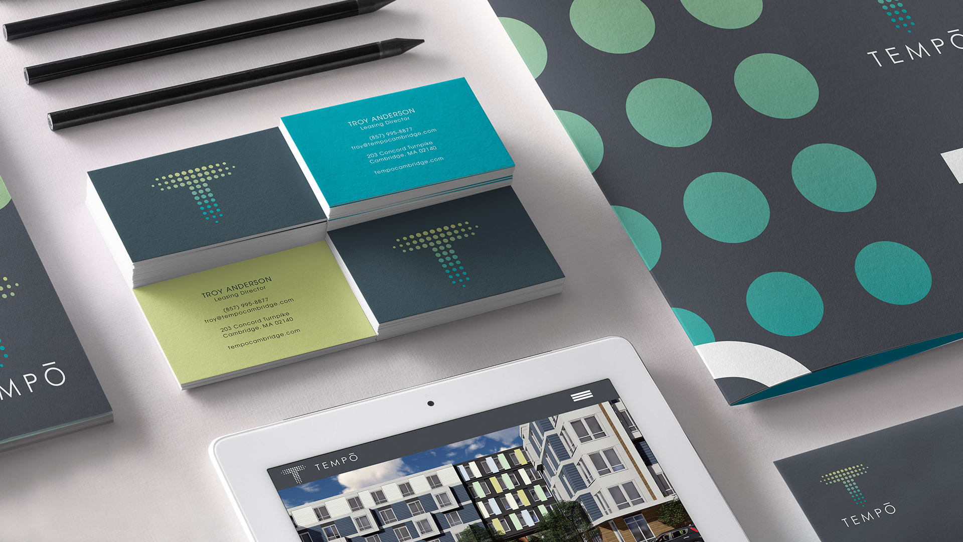 tempo apartment business cards stacked with ipad and folder