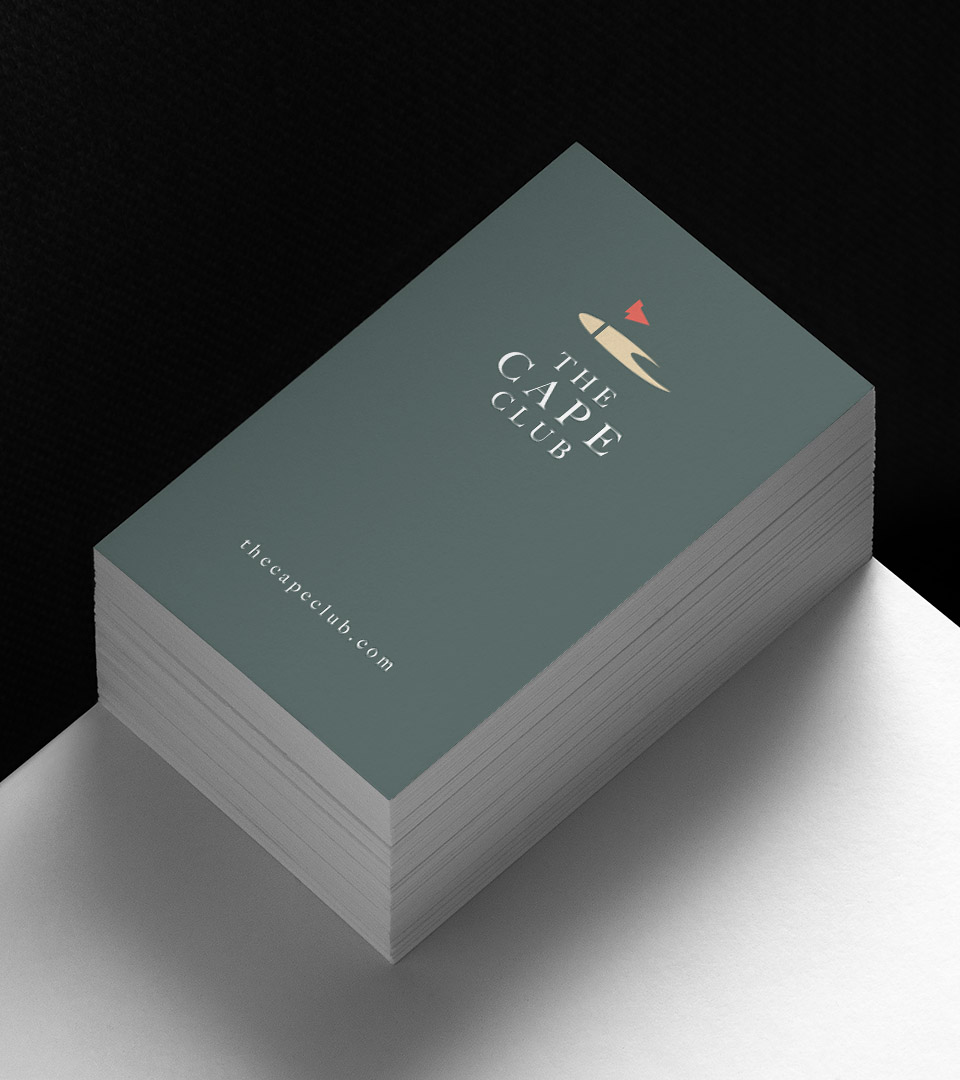 the cape club busness card on white table