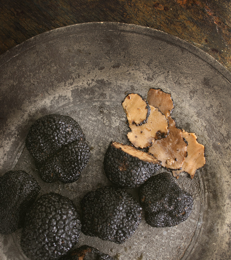 vela seaport black truffles on dark plate