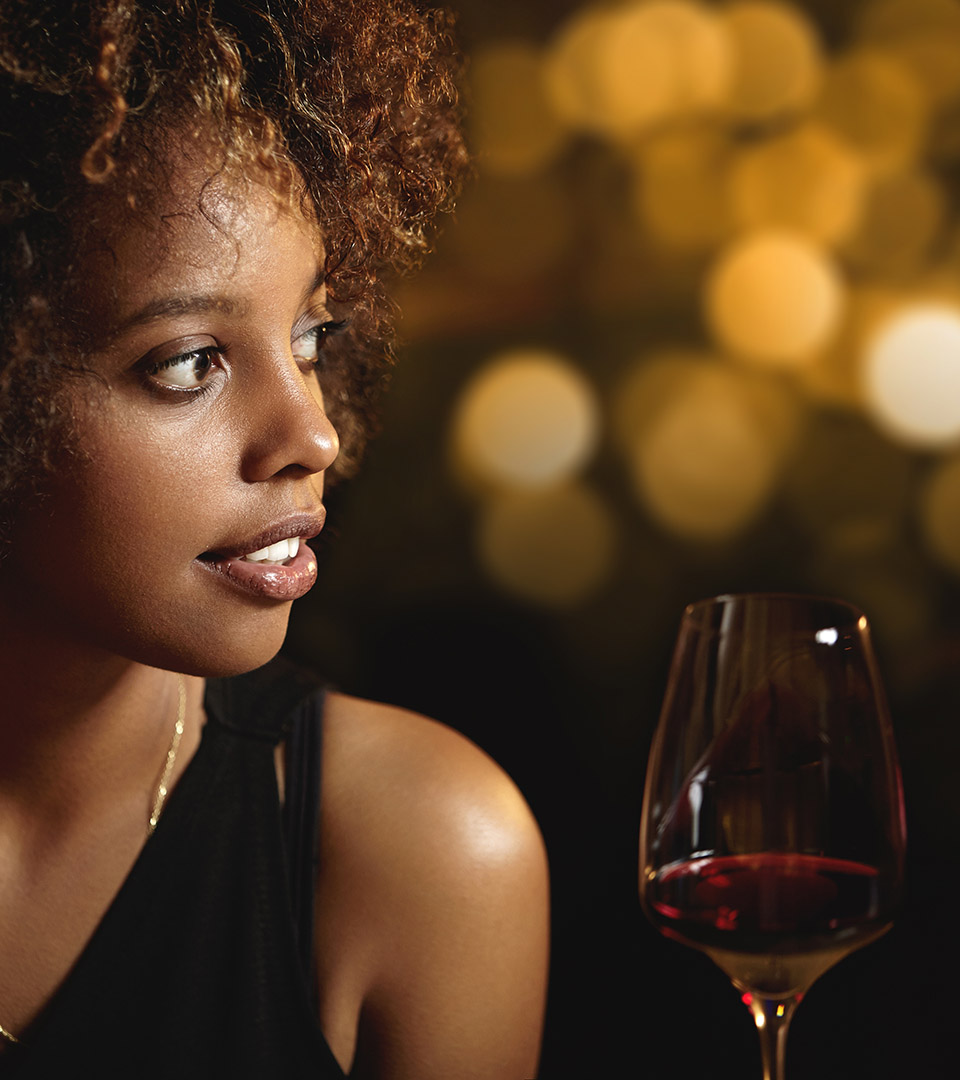 vela seaport black woman and glass of wine