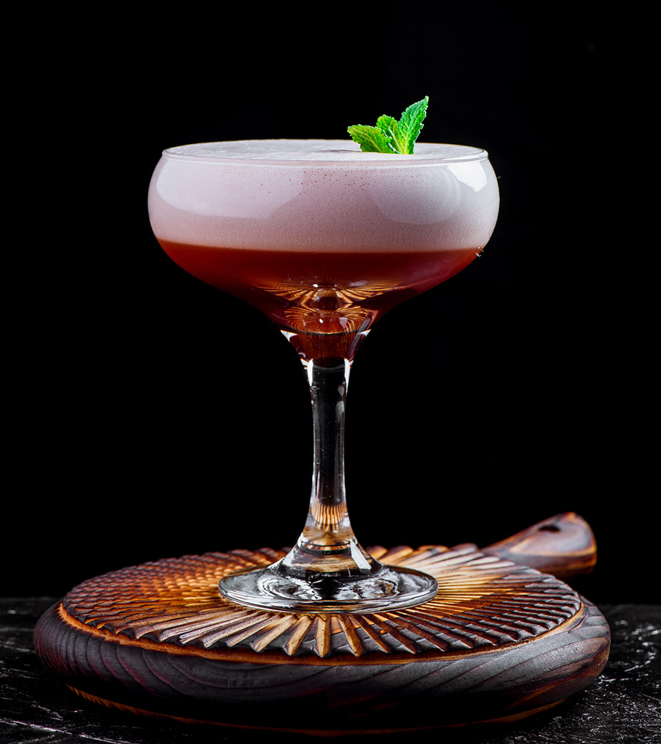 vela seaport cocktail against a dark background