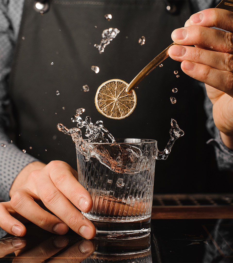 vela seaport man mixing drink with lemon